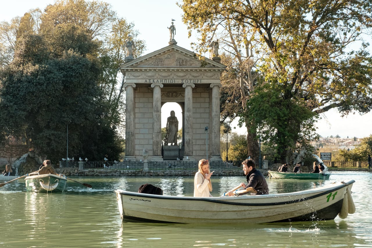 Couple enjoying a romantic boat ride near the Temple of Asclepius, Rome's picturesque landscape.
